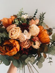 an arrangement of flowers in a vase on a table