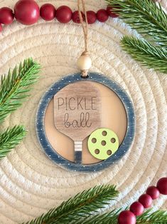 a christmas ornament with a ping pong racket and green polka dots