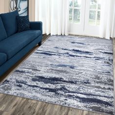 a living room with a blue couch and rug