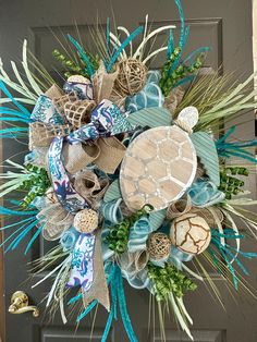 This beautiful turtle wreath is surrounded by the blue and green colors of tropical waters.  Wood and metal sea turtle, artificial fillers and a matching bow. This wreath is on a pine base lined with mesh for fullness.  36x37x10 Beach Theme Wreath, Coastal Wreaths Front Doors, Turtle Wreath, Seaside Wreath, Coastal Wreaths, Pineapple Wreath, Beach Wreaths, Mesh Crafts, Deco Mesh Crafts