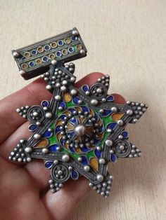 Beautiful traditional silver berber cross pendant, with nice quality enamel work, most likely handmade in Morocco (Tiznit) . This extremely well made vintage piece that tests silver. The enamel colors used are vivid and contrast wonderfully with the granulation work. Length : 9,2 cm (3,6 inches) Width : 7,6 cm (2,9 inches) Height : 1 cm (0,4 inches) Weight : 58 g Traditional Cross Jewelry For Collectors, Traditional Collectible Cross Jewelry, Old Silver Coins, Enamel Cross, Moroccan Jewelry, Enamel Jewelry, Coin Pendant, Silver Coins, Photo Jewelry