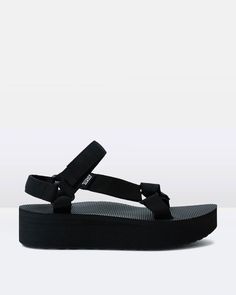 The Flatform by Teva is a platform sandal in a black colour way. This style features a durable polyester webbing upper that dries quickly after getting wet, a hook-and-loop closure that is easy to use and wear as well as a lightweight platform heel and rubber outsole for traction.Teva shoes are displayed in US WOMEN'S SIZES. Teva Flatform, Teen Shopping, Swim Trends, Flatform Sandals, Fashion Fits, Sandals Black, Summer Trends, Shop Swimwear, Drop Shipping