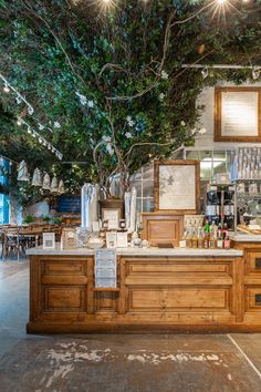 the inside of a restaurant with lots of counter space and lights hanging from the ceiling