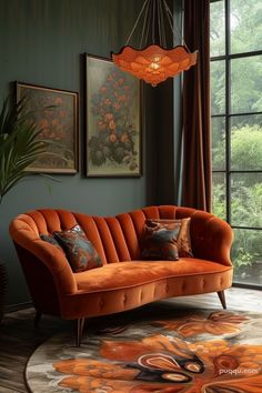 an orange couch sitting in front of a window