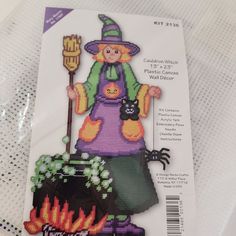 a cross stitch pattern for a halloween witch