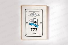 a playing card with the number 777 on it is hung up against a wall