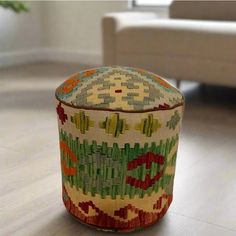 a colorful ottoman sitting on top of a hard wood floor