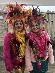 two women in colorful costumes standing next to each other