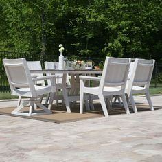 a white table with four chairs around it