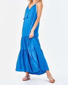 Strap halter maxi dress with side vents, cinching neck ties, deep back keyhole & armhole opening, tiered skirt. Simplicity in finest! Timeless exhibition of grace & serenity! Solid color woven on relaxed fit.Body length from HPS: 51", Sleeve length: N/A, Bust: 43" (Size Small) 100% TENCEL Machine wash cold, Line dry Imported Bohemian Tiered Maxi Dress With Tie Straps, Bohemian Tiered Maxi Dress With Tie Back, Blue Bohemian Maxi Dress With Tiered Skirt, Blue Tiered Maxi Dress For Vacation, Blue Maxi Dress With Tie Straps For Vacation, Sleeveless Tie Back Tiered Beach Dress, Flowy Tiered Maxi Dress With Tie Back, Tiered Skirt Maxi Dress With Tie Back, Sleeveless Tie Back Tiered Dress For Beach