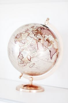 an old world globe sitting on top of a shelf