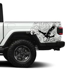 a white jeep with an eagle painted on the side