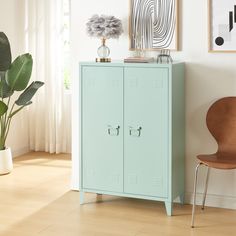 a blue locker next to a brown chair in a room with white walls and wooden floors