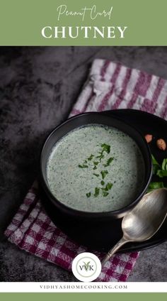 a black bowl filled with broccoli soup and garnished with parsley