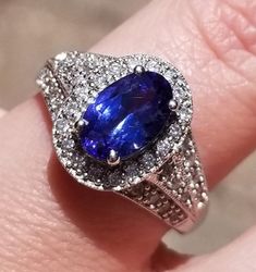 This is a Stunning 14K Tanzanite and Diamond Ring. I want you to know this is a Gem Quality Tanzanite with Exquisite Diamonds. That being said... This is a beautiful ring. It starts out with a 2.23 ctw Oval Tanzanite. You can see the blue and purple swirling around together to make a color that is hard to describe. It has .82 ctw. Of Bright, Shiny Diamonds that are VS clarity, G color. It just sparkles! This piece weighs 5.1 grams and it is a size 7. It is sizable by your local jeweler. I am pri Tanzanite And Diamond Ring, Tanzanite Diamond Ring, Beautiful Ring, Ring Size 7, Druzy Ring, Solitaire Ring, I Want You, Beautiful Rings, Class Ring