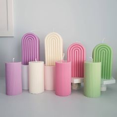 many different colored candles sitting next to each other