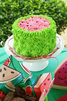 there is a cake on the table with watermelon decorations