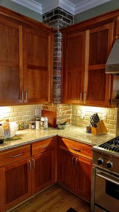 a kitchen with wooden cabinets and stainless steel appliances