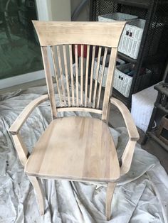 a wooden chair sitting on top of a bed