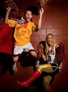 two people dressed as cheerleaders jumping in the air