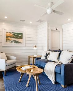 a living room with blue carpet and white walls