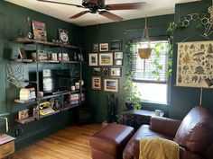 a living room with green walls and wooden floors