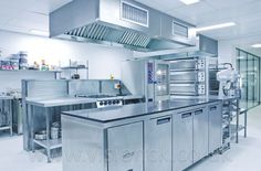 an industrial kitchen with stainless steel appliances and counters