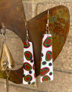 These fun boho style earrings come in 2 sizes. Each pair has different coloured dots randomly arranged on the earring. They have a slight texture to them. They are bright and fun. All of my earrings are handmade using Polymer Clay which keeps them very light to wear. No 2 pairs are ever the same and as they are hand made they may have very slight imperfections but that is the beauty of handmade. I take care to represent the true colour of the earrings. I hope you love wearing the earrings as much as I loved making them. Retro White Earrings For Gift, Colorful Handmade Playful Earrings, Playful Colorful Handmade Earrings, Trendy Colorful Earrings As Gift, Trendy Colorful Earrings For Gift, Retro White Drop Earrings, Funky White Jewelry For Gifts, Funky White Jewelry As A Gift, Handmade Funky Dangle Earrings