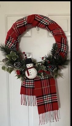 a christmas wreath with a snowman on it