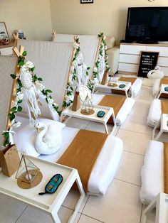 a room with white furniture and decorations on the floor