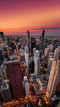 an aerial view of the city at night with skyscrapers and other tall buildings in the foreground