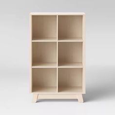 an empty bookcase with four shelves on one side and two drawers on the other