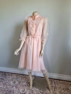 Stunning peach dream 70's dress with matching pearly buttons and a belted tie waist. What a soft and feminine dream in excellent condition  only flaw is loose elastic around wrists which could be easily fixed to suit buyer. Suit a size 6 to 8 modern AU. Vintage Peach Dress, Vintage Fitted Apricot Dress, Fitted Vintage Peach Dress, Vintage Peach Jewelry For Gifts, 70's Dress, Soft And Feminine, 70s Dress, Dream Dress, Favorite Outfit