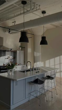 a kitchen with two bar stools next to an island