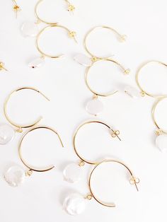 These simple and easy to wear hoops feature a 14k gold plated half hoop and hanging freshwater coin pearl. Available in two sizes to suit your style. Large measures 2 inches long (hoop measures 1.5 inches) and medium measures 1.5 inches long (hoop measures 1 inch) and huggies measure roughly .75” long. Coin Pearls, Jewelry Cleaner, Wedding Earrings, Online Accessories, Hair Pieces, Costume Jewelry, Handmade Natural, Sale Items, Beaded Jewelry