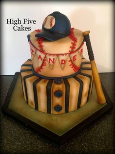 a baseball themed cake with a bat and helmet on top