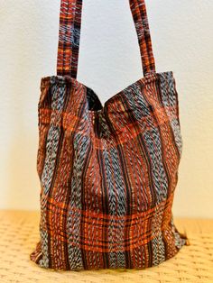 Beautiful handwoven tote bag made from "Tela de Corte"This multi purpose bag can be used as a tote, for shopping, travel, laptop carrier, or beach bag.Each piece is handmade featuring a unique design.As a unique handmade product each product may vary.No two are exactly the same and imperfections are to be expected and appreciated.What is Tela de Corte?Cortes are long pieces of treadle loom woven fabric that are used to make women's skirts. MEASUREMENTSLength: 15 inches Width: 14 inchesHandle len Handwoven Bucket Tote Bag For Daily Use, Handwoven Tote Bucket Bag, Everyday Bohemian Handwoven Bucket Bag, Everyday Shoulder Bag With Weaving Work, Bohemian Handwoven Everyday Bucket Bag, Bohemian Woven Cotton Beach Bag, Everyday Weaving Work Shoulder Bag, Handwoven Tote Bucket Bag For Everyday, Bohemian Bucket Bag With Weaving For Everyday Use