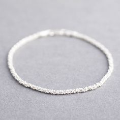 Tulip Jewellery | Sterling Silver Stardust Bracelet - a delicate way to sparkle in sterling silver £30.00 Silver Bracelet Designs, Clean Sterling Silver, Jewelry Logo, نظارات شمسية, Mens Bracelet Silver, Fine Silver Jewelry, Gold Armband, Silver Chain Bracelet, Silver Jewelry Handmade