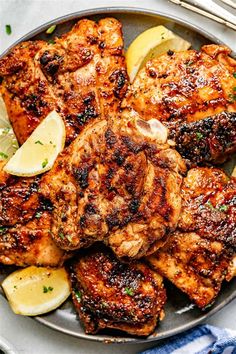 grilled chicken with lemon and parsley on a plate