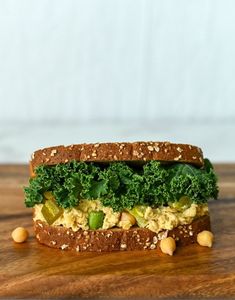 a sandwich with lettuce and chickpeas on it