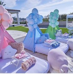 an outdoor party with balloons and stuffed animals