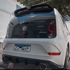 the back end of a white volkswagen car