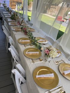 a long table set with gold plates and place settings