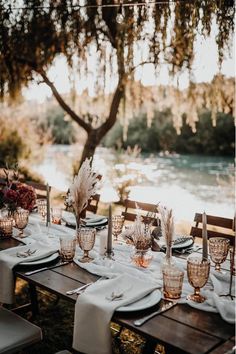 an outdoor dining table set with place settings