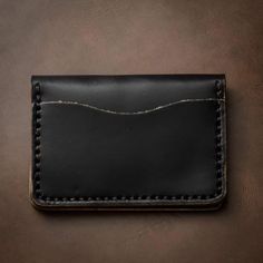 A Leather Wallet that goes Above and Beyond Your Expectations.When you hold this wallet you will love the supple and comfortable feel. Unlike most department store wallets, our leather features premium Horween leather, thick hand-stitching, and polished edges. Every inch of our craftsmanship has a high level of attention to detail. We build wallets to last a lifetime - and guarantee it.Our full-grain Horween leather means your wallet will develop character and patina. We hand-sew this wallet wit Black Trifold Wallet With Coin Pocket For Daily Use, Black Rectangular Card Holder With Coin Pocket, Black Bifold Wallet With Interior Card Slots, Classic Black Card Holder For Daily Use, Black Bifold Card Holder, Everyday Black Rfid Blocking Wallet, Classic Black Wallets With Card Slots, Black Bifold Wallet For Daily Use, Black Rfid Blocking Wallets For Everyday