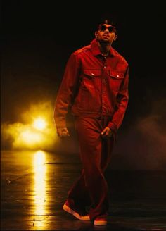 a man in red jumpsuit walking on stage