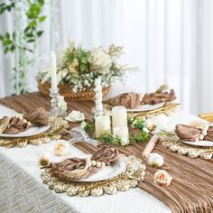 the table is set with plates and candles