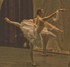 two ballerinas in white tutus are performing on stage