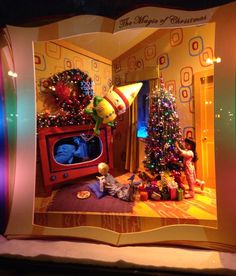 a window display with christmas decorations and children's toys in front of the tv