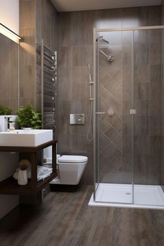 a bathroom with a toilet, sink and shower stall in the middle of the room